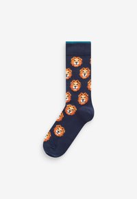 Marineblaue Socken aus weichem Stoff, mit einem wiederholten Muster von orangen Löwengesichtern mit weißen Akzenten und einem türkisen Bündchen.