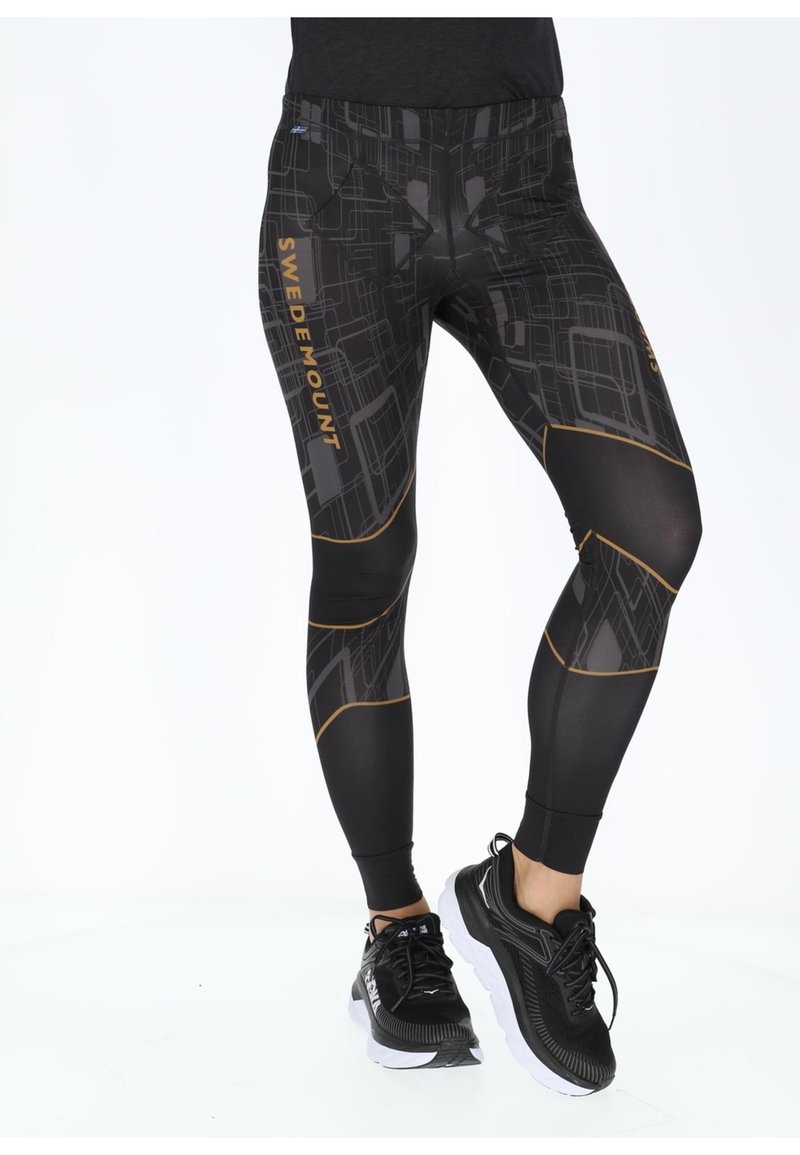 Black leggings with a geometric pattern, gold "SWEDEMOUNT" text, and contrasting seams. Features a high waistband and pockets on the back.