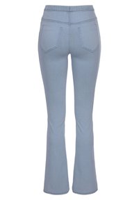 Light blue denim flared jeans with a smooth texture, elastic waistband, and two back pockets featuring decorative stitching.