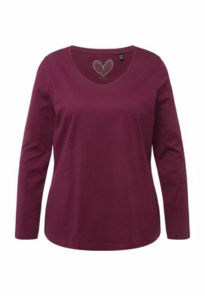 Long-sleeve V-neck shirt in burgundy cotton, featuring a heart pattern near the neckline, with a slightly curved hem and soft texture.
