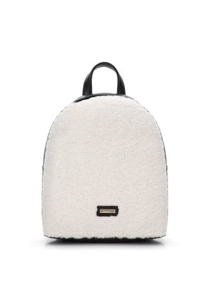 Sac à dos en fausse fourrure blanche avec une forme arrondie, des accents en cuir noir et une plaque logo dorée à l'avant. Poignées supérieures doubles pour le transport.