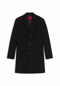 Cappotto in misto lana nera con revers a punta, chiusura a cinque bottoni e tasche laterali. L'interno è foderato con un motivo sottile.