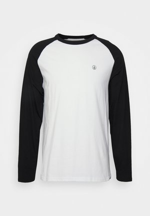 Long-sleeve shirt featuring a white body with black raglan sleeves, round neckline, and a small black logo on the chest. Cotton material.