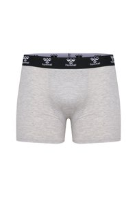 Grå boxershorts i mjuk bomull, med ett svart elastiskt midjeband som har den upprepade vita "hummel" logotexten. Slät textur och figurnära design.