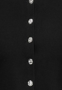 Black cardigan featuring metallic, textured buttons down the front. The fabric has a smooth texture and a fitted design.