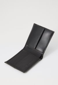 Black leather wallet with a bi-fold design, featuring multiple card slots and a smooth texture. Minimalist and sleek appearance.