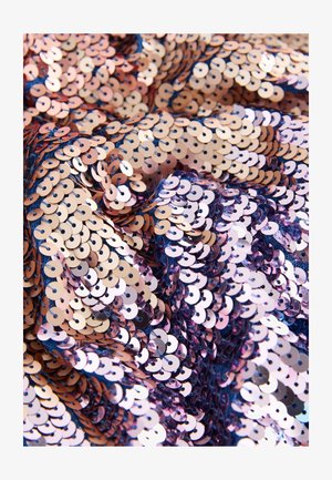 Sequined fabric with circular rose gold and pink sequins on a dark background, creating a textured and reflective surface.