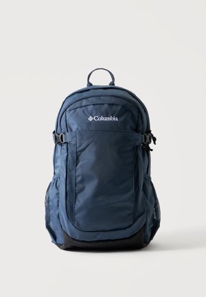 Sac à dos Columbia bleu marine avec poche zippée à l'avant, poches latérales en mesh, bretelles réglables et poignée de transport supérieure sur un fond uni.