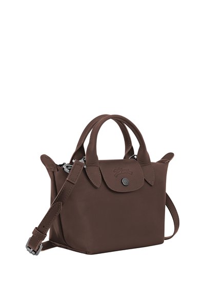 Small dark brown leather handbag with double handles, flap closure with button, and adjustable shoulder strap.