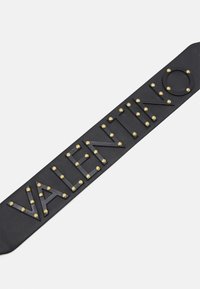 Black leather belt with raised letters spelling "VALENTINO" accented by gold studs on each letter against a white background.