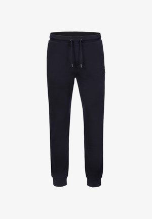 Pantaloni sportivi blu navy realizzati in misto cotone, con cintura in vita elastica e cordino, polsini a coste e una toppa con logo laterale.