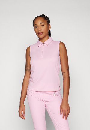 Pink sleeveless polo shirt with a zippered neck, featuring a textured fabric and a small silver accent. Worn with matching pink pants.