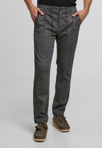Gray patterned trousers with a relaxed fit, featuring an elastic waistband, side pockets, and textured fabric. Accented with belt loops.