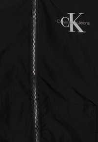 Calvin Klein Jeans MONOLOGO ESSENTIAL JACKET UNISEX - Allvädersjacka - black