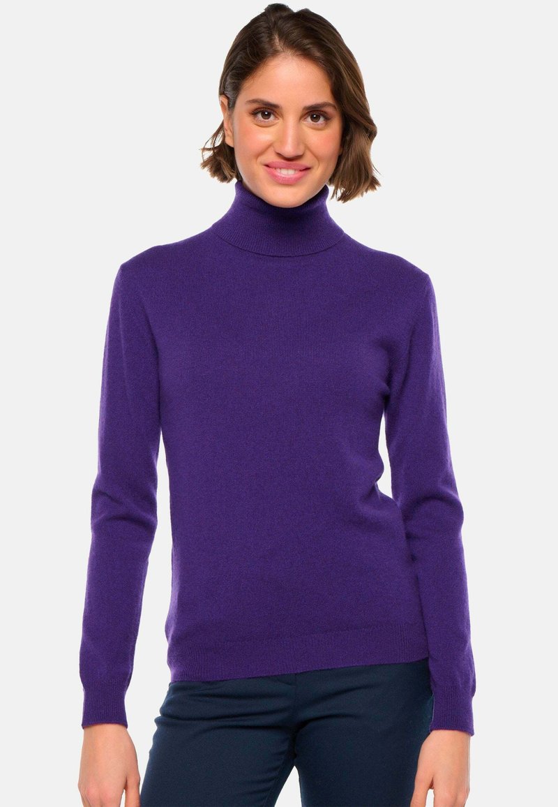 Pull en col roulé violet en tissu doux, avec des manches longues et des poignets côtelés, présentant un col ajusté.