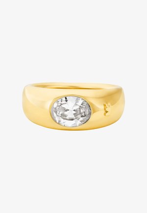 Χρυσό δαχτυλίδι με λείο, στρογγυλεμένο σώμα που διαθέτει ένα μεγάλο οβάλ διαυγή πολύτιμο λίθο τοποθετημένο στο κέντρο. Πολύ γυαλιστερή φινίρισμα, ελάχιστες λεπτομέρειες.