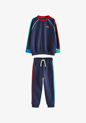 Navy sweatshirt with rainbow logo, red and green accents, and long sleeves. Matching jogger pants with side stripes and elastic waistband.