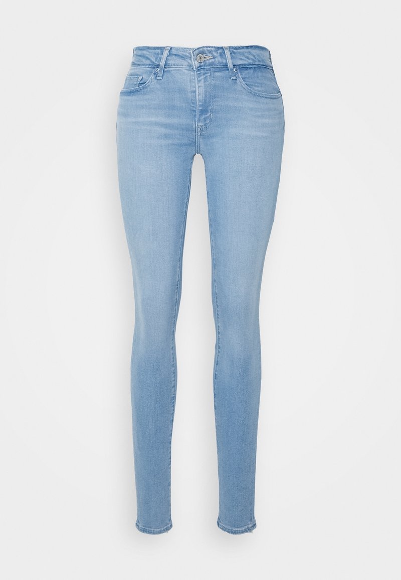 Jean skinny bleu clair en denim, avec une taille mi-haute, un design classique à cinq poches et un léger délavage autour des cuisses.