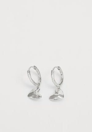 Silver hoop earrings with an abstract, smooth shape hanging from each, featuring a shiny and polished finish.