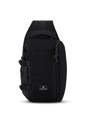 Zwarte compacte slingrugzak met gewatteerde schouderriem, voorvak met ritssluiting, zijgespen en Johnny Urban logo patch.