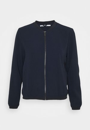 Blouson bomber bleu marine zippé, manches longues avec poignets, col et bas côtelés, présenté sur fond blanc.