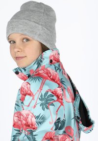 Children's jacket with a blue base, detailed with pink flamingos and green leaves. Features a high collar and black interior lining.