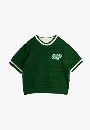 Vihreä neulepusero lyhyillä hihoilla, jossa on valkoinen ribbikaulus ja hihansuut sekä kameleontin paikka edessä.