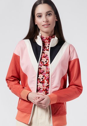 Kleurgeblocked zip-up jack met koraal, roze en zwarte panelen. Bevat een bloemenhalstrui eronder en ribgebreide manchetten. Soepele textuur.