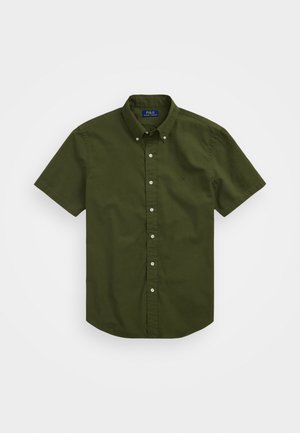 Kortermet skjorte med knapper i mørkegrønn bomull, med klassisk krage og liten brodert logo på brystet. Enkelt tekstur, vanlig passform.