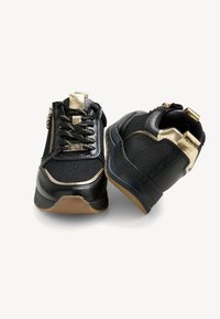 Scarpe sportive nere caratterizzate da un mix di tessuto testurizzato e materiale sintetico liscio, arricchite da dettagli in oro e una suola in gomma.