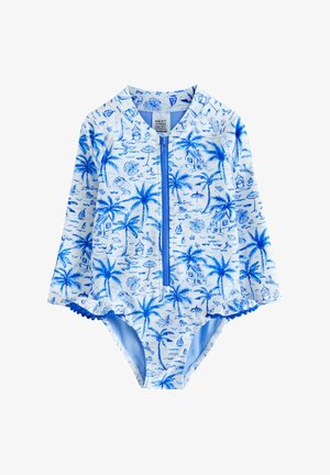 Maillot de bain à manches courtes bleu et blanc avec une fermeture éclair à l'avant, imprimés de palmiers et de plage, avec des accents à volants texturés sur les jambes.