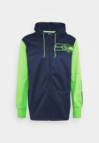 Navy and lime green zip-up hoodie with a front pocket. Features a bold Seahawks logo on the left side and branding on the right sleeve.