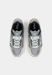 Gray athletic sneakers with a textured upper, white laces, turquoise accents, and a chunky sole design. Logo displayed on tongue.