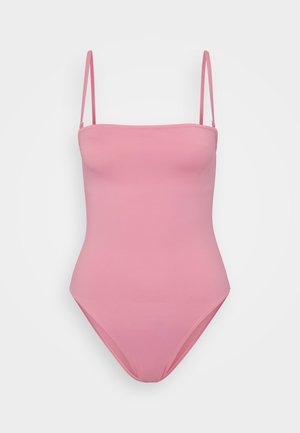 Rožinė vienos dalies maudymosi kostiumėlis su plonomis reguliuojamomis petnešėlėmis, lygia tekstūra ir prigludusia forma. Matomų dekoracijų ar raštų nėra.