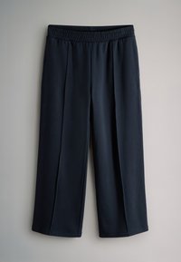 Meresinine lühikesed püksid elastse vöökohaga, valmistatud siledast kangast, millel on kaks esist voldikuga ja sirge, laia säärega disain.