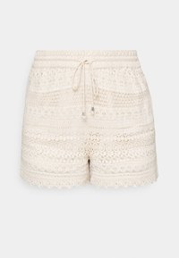 Crème haakshorts met een elastische tailleband en trekkoord. Kenmerkt zich door ingewikkelde kantpatronen en een golvende zoom. Lichtgewicht textuur.