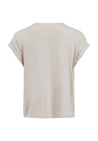 Top beige à manches courtes avec une coupe décontractée, une texture douce, un col rond et des poignets retroussés, conçu pour le confort et le port décontracté.