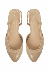 Beige slingback heels with a pointed toe. Made of smooth and suede materials, featuring a subtle sheen and minimalistic design.