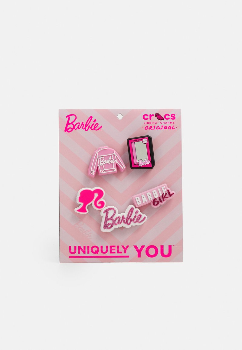 Set of five pink Barbie-themed Crocs charms featuring a jacket, mirror, silhouette, and text elements. Mounts on footwear. Card with chevron design.