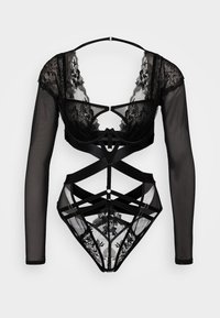 Zwarte kant en gaas bodysuit met lange mouwen, ingewikkelde patronen, uitsnijdingen en geometrische bandjes. Beschikt over accenten van goudkleurig hardware.