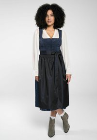 Traditional dress featuring a navy zippered bodice with embroidery, a black satin skirt, and grey ankle boots with a smooth texture.