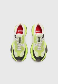 Neon green and gray sports shoes with a mesh upper, thick rubber sole, and contrasting black accents. Features round laces and branded insoles.