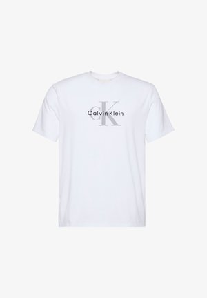 T-shirt bianca a maniche corte con logo "Calvin Klein" grigio e grafica "ck" sul davanti. Realizzata in morbido cotone.