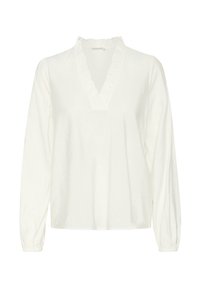 White long-sleeve blouse with a deep V-neck and ruffled trim. Soft fabric with subtle textured pattern. Cuffs are gathered for a relaxed fit.