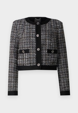 Schwarz-weißes Tweed-Jackett mit Rundhals, verkürztem Schnitt, durchgehender Knopfleiste und zwei vorderen Taschen mit dekorativen Knöpfen.