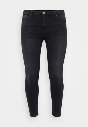 Black skinny jeans made of denim with a smooth texture. Features a front button closure, belt loops, and five pockets.