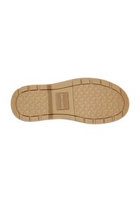 Skechers skosula i tan gummi, med en vågmönstrad yta, logotyp och konturer för grepp och stöd.