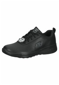 Scarpe sportive nere con una tomaia liscia simile alla pelle, design con lacci e suola in gomma testurizzata. Presentano un logo sul lato e sulla linguetta.