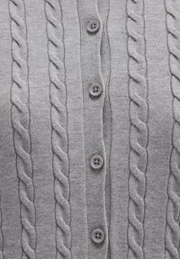 Cardigan grigio a maglia con motivo a trecce, cinque bottoni grigi e collo a costine. Texture liscia con un design aderente.