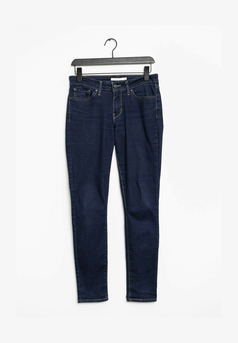 Mörkblå smala jeans i denim, med fem fickor, dragkedja och bälteshål i midjan. Slät textur och åtsittande design.